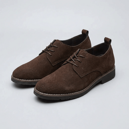 Side view of a men's Oxford dress shoe with refined stitching and a low heel
