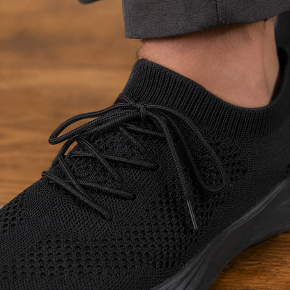 Close-up of the knit upper and lace-up details on men's casual sneakers