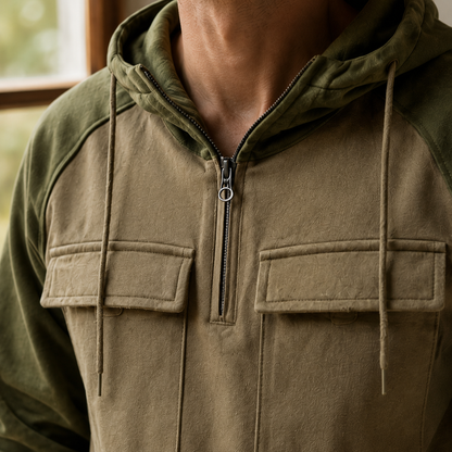 Front view of a men's gray utility hoodie with a structured hood and long sleeves