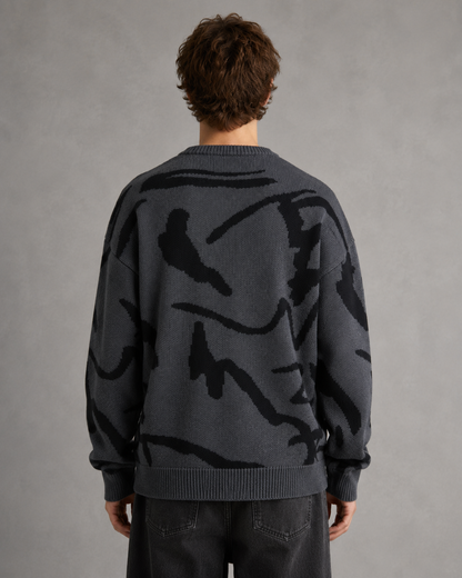 Side view of the men's abstract graphic sweater with a relaxed silhouette.