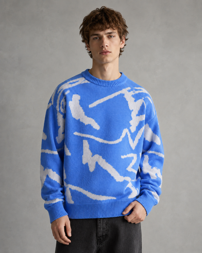 Men's abstract graphic knit sweater shown from the front in a relaxed fit.