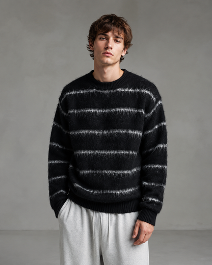 Front view of a men's striped knit sweater with a relaxed boxy fit