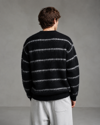 Back view of a men's striped knit sweater showing the relaxed silhouette