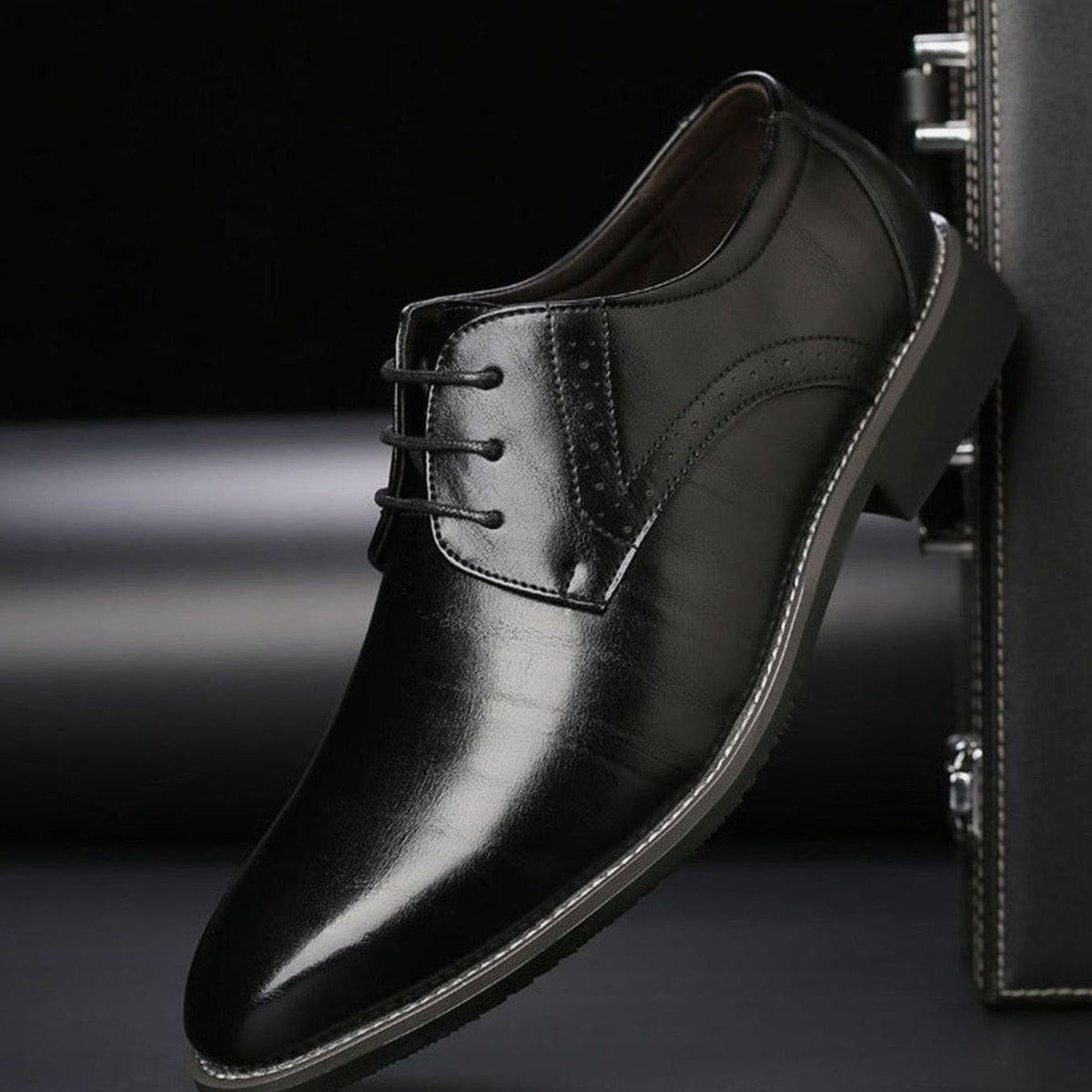 Pair of men's leather brogue dress shoes displayed together