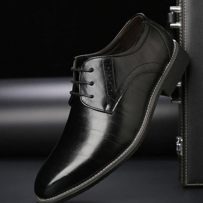 Pair of men's leather brogue dress shoes displayed together