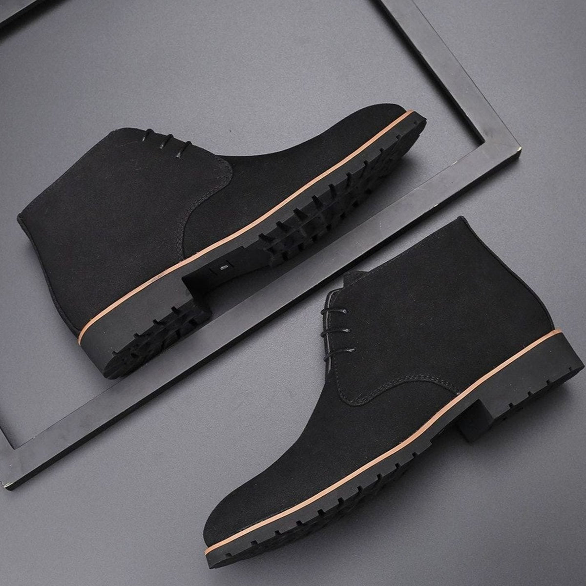 Men's suede chukka ankle boots shown from the side with lace-up fronts